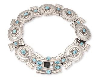 1
Mid-20th century; Dine
A Navajo Concho Belt
Buckle stamped: M / Silver
Comprising seven oval stamped silver conchos aand eight butterfly stamped silver conchos with matching buckle, each with set turquoise and set to a black leather strap
Buckle: 3" H x 4.375" W; each oval: 3.125" H x 3.875" W; butterfly: 3" H x 1.5" W; belt: 1" H x 37" L
Estimate: $700 - $900