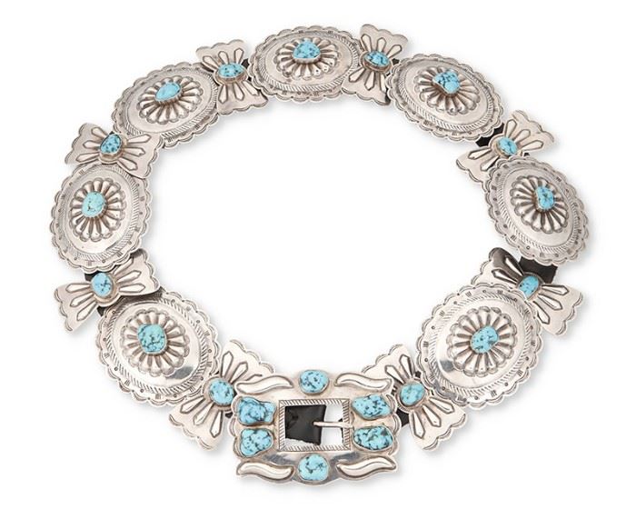 1
Mid-20th century; Dine
A Navajo Concho Belt
Buckle stamped: M / Silver
Comprising seven oval stamped silver conchos aand eight butterfly stamped silver conchos with matching buckle, each with set turquoise and set to a black leather strap
Buckle: 3" H x 4.375" W; each oval: 3.125" H x 3.875" W; butterfly: 3" H x 1.5" W; belt: 1" H x 37" L
Estimate: $700 - $900