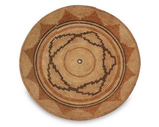 15
Late 19th/early 20th century; Southern California
A Large Polychrome California Mission Basket
A large coiled tray with high sides and star and flower geometric motifs, with a central silver button
3.75" H x 26" Dia.
Estimate: $2,000 - $3,000