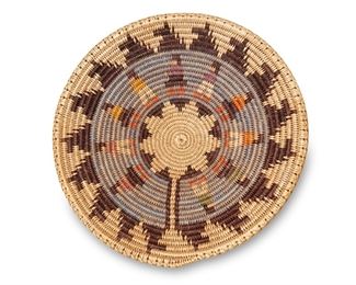 33
Late 20th/21st century
Attributed To Sally Black (B.1958; Dine)
A large polychrome Navajo wedding basket
A coiled tray basket with a central star and a central band of multicolored standing figures with stylized animals to outer border
3.5" H x 16.75" Dia.
Estimate: $500 - $700