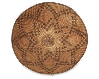 50
Early 20th century; Akimel O'odham, Southwest United States
A Large Pima Basket
Coiled large tray with black center and an eight-pointed star motif with original hang tag
5" H x 17.75" W
Estimate: $400 - $600