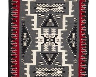 53
Mid/late 20th century; Dine
A Large Navajo Rug
Woven in grey, black, red, and cream wool in an elaborate storm pattern with waterbug motifs and stepped sawtooth borders
74.5" H x 54.5" W
Estimate: $800 - $1,200