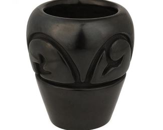 85
Circa 1970
Mela Youngblood (1931-1991, Santa Clara Pueblo)
A Santa Clara black ware pottery jar
Signed and dated to base: Mela Youngblood / Santa Clara Pue / 11-2-70
A carved cylindrical blackware jar with curvilinear banded motif
4.5" H x 4.125" Dia.
Estimate: $800 - $1,200