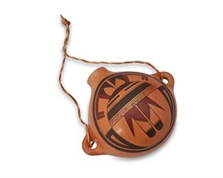95
Loren Ami (B. 1968, Hopi-Tewa)
A polychrome pottery canteen, 1997
Signed and dated to underside: Loren Ami / 6/97 / [insect cipher]
The canteen with polychrome avian and face motif on burnished buff slip glaze with hide strap
4.25" H x 7.5" W x 6" D
Estimate: $400 - $600
