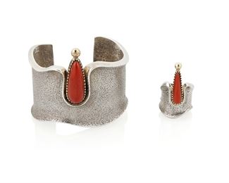 103
Late 20th/21st century
Edison Cummings (B. 20th Century; Dine)
A set of Navajo 14k gold and tufa cast silver jewelry with set coral
Each stamped: E. Cummings / 14K
Comprising a coral set tufa cast silver cuff (6.5" total inner C x 2.375" H, with a 1.125" opening) with a matching ring (Ring size 8; 1.625" H), 2 pieces
146.6 grams gross
Estimate: $1,000 - $1,500