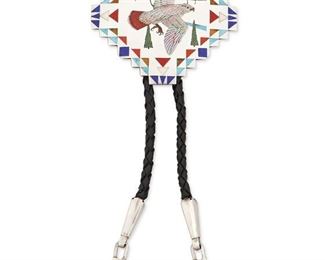 107
Late 20th/21st century
Harlan Coonsis (B.1958; Zuni)
A Zuni inlaid bolo
Stamped: H.R.Coonsis / Zuni / [Sunface symbol]
A stepped diamond silver bolo with an inlaid abalone red tailed hawk with enameled evergreen landscape and inlaid coral, tiger's-eye, lapis, and turquoise inlay with inlaid dangle tips all mounted to a black braided leather cord
Bolo: 3" H x 3" W; each tip: 2.5" H; cord: 37" L
Estimate: $600 - $900