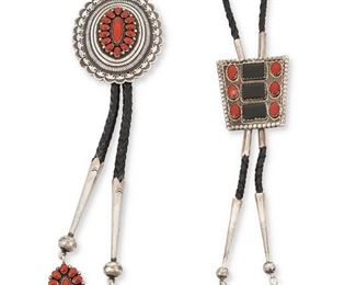 112
Mid/late 20th century
Two Southwest Bolos
Two works:

Ernest Roy Begay
(b. 1956, Dine)
A large stamped and pierced sterling silver Navajo concho bolo with central cluster set coral and dangles, all set on a braided leather strap
Stamped: ERB / Sterling
Bolo: 3" H x 2.5" W; each dangle: 1.5" H; strap: 42" L

A set onyx and coral trapezoidal bolo with set onyx dangles, all mounted on a braided leather strap
Stamped: JW
Bolo: 2" H x 2" W; each dangle: 1.25" H; strap: 30" L

2 pieces
172.1 grams gross
Estimate: $500 - $700