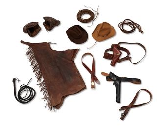 125
20th century; Eagar, AZ
A Group Of Western Leather Goods From John Wayne's Estate, 26 Bar Ranch
Eleven works:

A US military holster and belt in black leather, with brass "US" buckle (for 1911)
Belt: 1.625" H x 49" L; holster: 15.5" H x7" W

A Clark leather belt and holster with magazine carriers and shoulder strap
Stamped: Clark Holster / Los Angeles Calif / 384 / 32
Model 384 size 32, belt size 34
Belt: 2.25" H x 42.75" L; holster: 10.5" H x 5" W

A John Wayne commemorative brown leather belt, lacking holster
Belt stamped: DUKE; Plaque stamped: John Wayne / Commemorative Holster and Belt Set /No. 1746 / of 3000 / Bianchi Leather / 1981 Wayne Ent.
Size 38; 1.75" H x 44" L

An associated tooled brown leather belt with silver-toned buckle
1.375" H x 42" L

A pair of brown fringed leather chaps with brass zip closures
Stamped to leather at lower edge: VI; stamped to zipper: Serval
Waist: 37" - 41"; 42" L; inseam: 27" L

Two cowboy hats, including a New West by Bailey mustard wool fel