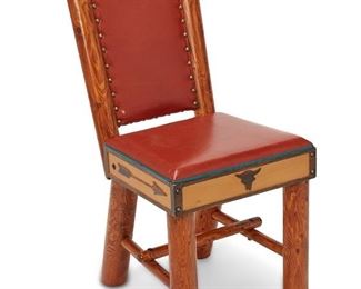 127
Circa 1940s
A Wyoming Furniture Co. Steer Head Side Chair
A Wyoming Furniture Company pine and painted tulip poplar chair with orange leather upholstery and turquoise piping; chair has upholstered back, accented with hammered brass tacks and a bison skull motif; additionally, the wood surrounding the seat is decorated with a bison skull and yellow-painted arrow motifs
35" H x 16" W x 14" D
Estimate: $1,500 - $2,500