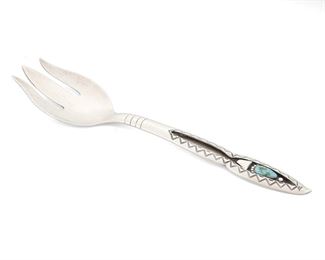 146
Late 20th century
A Navajo-Style Silver Serving Fork
Designed with a shadowbox handle with inset turquoise and stamped motifs to edges
9.875" H x 2.375" W<br />3.035 gross grams troy
Estimate: $150 - $250