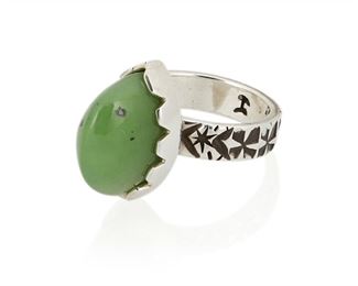 149
21st century; New Mexico, USA
Jared Chavez (B. 1980s; San Felipe Pueblo)
Stamped: JC [conjoined]
A Siberian green jade and silver ring with incised geometric motifs to band
Ring size: 8; 0.625" H<br />12.0 grams gross
Estimate: $400 - $600