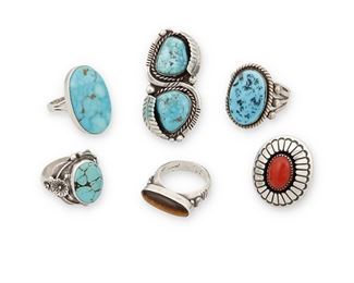 152
Mid/late 20th century
A Group Of Southwest Silver And Stone Rings
Six works:

Bessie Yazzie
(b. 20th century, Dine)
A Navajo silver shadowbox coral set ring
Stamped: Bessie Yazzie
Ring size: 7.5

Harrison Jim
(b. 20th century, Dine)
A Navajo sterling silver set turquoise ring
Stamped: H JIM / Sterling
Ring size: 13

Oscar Alexius
(b. 1949, Dine)
A Navajo sterling silver and set tiger's eye ring
Stamped: O.A. / Sterling
Ring size: 9.5

A Carlos Tsipa set turquoise silver ring
Stamped: C. Tsipa
Ring size: 9

A sterling silver set turquoise ring with foliate motifs
Stamped: Circle JW [for Circle JW shop] / Sterling
Ring size: 10

A silver ring with double set turquoise and applied leaf motifs
Appears unmarked
Ring size: 8.25

6 pieces
84.2 grams gross
Estimate: $200 - $400