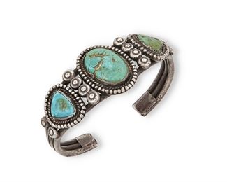 158
Early/mid-20th century; Dine
A Navajo Turquoise Cuff Bracelet
Appears unmarked
Comprising a three wire silver cuff with three set turquoise stones with handmade bezels
7.25" total inner C x 1.25" H, with a 1.125" gap<br />82 grams gross
Estimate: $300 - $400