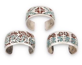 161
Mid/late 20th century
Three Southwest Santo Domingo Style Cuff Bracelets
One stamped with unknown arrowhead mark with circle within
Comprising three cuffs with turquoise and coral chip inlay, one with geometric textile motifs (6.625" total inner C x 1" H, with a 0.875" gap) and two with abstract figural motifs (Each: 6.25 total inner C x 1.25" H, with a 1.25" gap), 3 pieces
179.3 grams gross
Estimate: $300 - $500