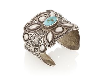 162
Mid-20th century
Art Tafoya (B. 20th Century, Yaqui)
A Yaqui southwest silver and turquoise cuff bracelet
Stamped: AT [conjoined] / Sterling
A wide sterling silver cuff with high relief, deep stamping and central bezel set turquoise
6.75" total inner C x 2.125" H, with a 1" gap<br />113.6 grams gross
Estimate: $400 - $600