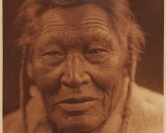 201
Edward S. Curtis
1868-1952
"Tsaassi-Mis-Salla "Crow With Necklace" - Sarsi," Plate 618 From "The North American Indian" Volume 18
Photogravure in brown on tissue-thin Japanese paper
From the Suffolk Engraving Co., Cambridge MA edition printed after the 1926 original photograph copyrighted by Curtis; with the title, plate number, copyright, publisher, and artist name all printed in the blank outside the image
Image: 15.625" H x 11.625" W; Sheet: 17.375" H x 12.75" W
Estimate: $400 - $600