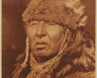 202
Edward S. Curtis
1868-1952
"Apio-Mita ("White Dog") - Blood," Plate 648 From "The North American Indian" Volume 18
Photogravure in brown on tissue-thin Japanese paper
From the Suffolk Engraving Co., Cambridge MA edition printed after the 1926 original photograph copyrighted by Curtis; with the title, plate number, copyright, publisher, and artist name all printed in the blank outside the image
Image: 15.375" H x 11.75" W; Sheet: 17" H x 12.875" W
Estimate: $500 - $700