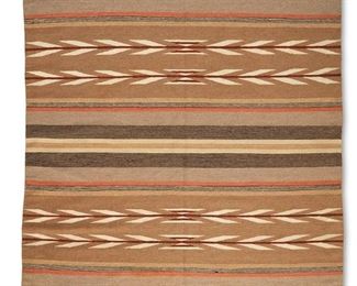207
Mid-20th century; Dine
A Navajo Crystal Rug
Woven in brown, grey, orange, pale yellow, mustard, and black wool with alternating striped bands and bands with geometric arrow motifs
84" H x 65.5" W
Estimate: $700 - $900