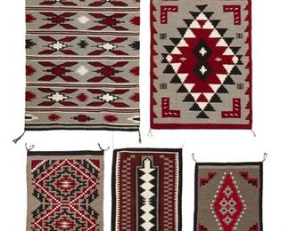 215
Mid/late 20th century; Dine
A Group Of Small Navajo Mats
Five works woven in red, grey, cream, and black wool comprising a Chinle-style mat banded with X motifs (43.5" H x 29.75" W), a regional mat with two small central diamonds within a large red diamond (36" H x 26" W), a small mat with an elaborate double diamond (27.25 " H x 20" W), a narrow mat with a central column of cream diamonds (27" H x 17.5" W), and a small mat with a single central diamond motif (22" H x 16.5" W), 5 pieces
Estimate: $500 - $700