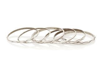 224
Mid/late 20th century; Dine
Six Navajo Silver Bangle Bracelets
Each appears unmarked
A group of six silver bangles, each with various stamped designs
Largest: 8.125" inner C x 0.25" H; smallest: 7.75" inner C x 0.125" H<br />125.3 grams<br />6 pieces
Estimate: $200 - $400