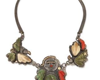 227
Late 20th/21st century; Cochiti-Zuni
Jolene Eustace (B. 20th Century, Zuni/Cochiti Pueblo)
A large Pueblo stone set necklace
Stamped: JAE / 18K / Sterling
An oxidized sterling silver Sunface bib necklace with two long curved textured silver links and three stone set links with turquoise, coral and shell, and applied silver and 18k yellow gold motifs
18" L x 2.875" H<br />124.6 grams gross
Estimate: $800 - $1,200