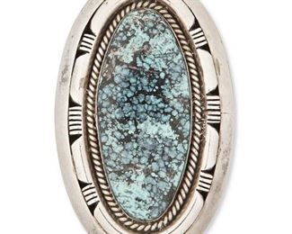 231
Late 20th century
Esther Wood (B. 1946, Dine)
A Navajo silver and turquoise pendant
Marked: Esther W.
A large oval silver and set turquoise pendant with incised edging
2.75" H x 1.625" W<br />62.8 grams gross
Estimate: $200 - $300
