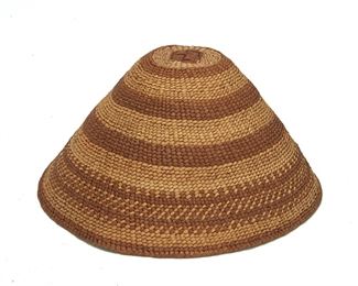 239
Late 19th/early 20th century
A Pacific Northwest Coast Basketry Hat
A twined banded hat with added woven interior fit band
5.75" H x 11.5" Dia.
Estimate: $200 - $400