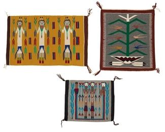261
Late 20th century; Dine
A Group Of Navajo Pictorial Textiles
Three works:

Norah Bitah
(b. 20th century, Dine)
A small Navajo Tree of Life textile woven in grey, green, cream, and red wool with cornstalk and birds and feathers and pot below
24.25" H x 20.25" W

Two Navajo textiles with Yei figures including a Navajo Yei weaving with three Yei figures on a yellow field (20" H x 32" W), and a small Navajo Yei mat with two figures surrounded by a rainbow god and flanked by blue corn (15.5" H x 18.5" W), 2 pieces

3 pieces total
Estimate: $400 - $600