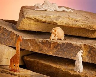 278
Esteban Najera (B. 20th Century, Zuni)
A group of Zuni carved fetish items, late 20th/21st century
Each marked for Esteban Najera
Comprised of an eagle and a dragon carved in bone, a skull with a painted mohawk carved from tagua nut and a carved amber giraffe, 4 pieces
Dragon: 0.875" H x 3.25" L
Estimate: $100 - $200