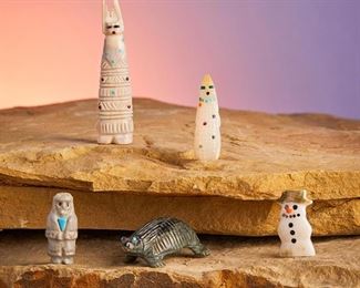 279
Late 20th/21st century
A Group Of Zuni Stone Fetish Figures
Each variously marked
Comprising a nephrite turtle (Karen Zunie), a carved bone man (Marlo Booqua), a mother-of-pearl corn maiden (DN), a bone/antler corn maiden (Carl Etsate), and a green snail shell snowman (Cheryl Bayuka), 5 pieces
Antler corn maiden: 2.5" H x 0.625" W
Estimate: $100 - $200