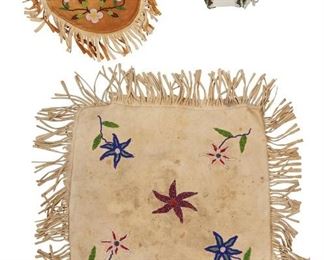 300
Mid/late 20th century
A Group Of Native American Beaded Hide Bags
Comprising an Athabascan fringed hide pillow cover with floral glass seed beads
(15" H x 15.5" W; fringe: 3.5"), a Woodlands beaded suede hide drawstring pouch with glass seed beads in floral motifs to both sides (10" H x 8" W; fringe: 2.375"), and a Sioux six-tail hide drawstring bag with glass seed beaded seams (6" H x 6" Dia. closed; each section: 8" H x 3" W), 3 pieces
Estimate: $100 - $200
