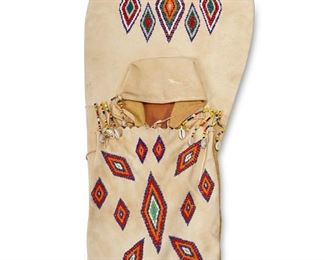 301
Mid/late 20th century
A Native American Beaded Hide Cradleboard
Comprising a hide-covered wood cradleboard with multicolored beaded diamond motifs to the headboard and fabric-lined cover, and with beaded strands with cowrie shells
36" H x 16.5" W
Estimate: $200 - $400