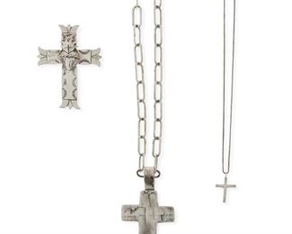 305
Late 20th/early 21st century; New Mexico
A Group Of Silver Jewelry
Comprising a Juan Lopez stamped and overlay sacred heart cross pendant (stamped: JL [conjoined]; 2.375" H), a Lawrence Baca cast cross pendant (stamped: LB / Sterling; 2.75" H), a Michelle Tapia small sacred heart cross pendant necklace (cross stamped: Tapia / ©; detachable chain stamped: Italy / 925 / Diagonal; 18" L x 0.875" H), and a chunky paper clip chain link necklace (clasp stamped: 925; 22"L), 5 pieces
56.4 grams
Estimate: $150 - $250