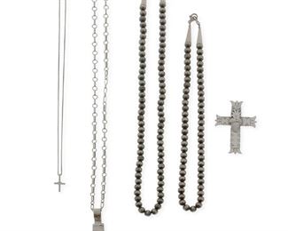 307
Late 20th/early 21st century; New Mexico
A Group Of Silver Jewelry
Comprising two silver bead necklaces (each clasp stamped: 925 [likely by Lawrence Baca]; 18" L and 22" L), a Lawrence Baca cast cross pendant (stamped: LB / Sterling; 2.75" H), a Juan Lopez stamped and overlay sacred heart cross pendant (stamped: JL [conjoined]; 2.375" H), a Michelle Tapia small sacred heart cross pendant necklace (cross stamped: Tapia / ©; detachable chain stamped: Italy / 925 / Diagonal; 18" L x 0.75" H), and a long paperclip link chain necklace (clasp stamped: 925; 41" L), 7 pieces
101.1 grams
Estimate: $200 - $300