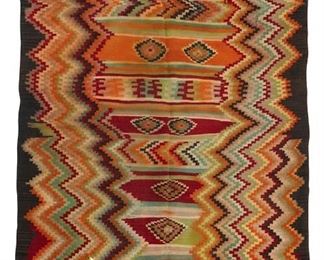 311
Early 20th century
A Large Mexican Rug
Woven in a variety of colored wool with multicolor zig zag side columns and a banded interior with serrated diamond motifs
100" H x 74" W
Estimate: $800 - $1,200