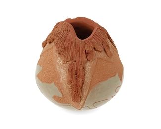 323
Circa 1995
Russell Sanchez (B. 1963, San Ildefonso Pueblo)
A small Pueblo pottery vessel
Signed to base: Russell Sanchez / 1995
A small pottery "volcano" vase with sgraffito greenware bears to base
4.5" H x 4" Dia.
Estimate: $500 - $700