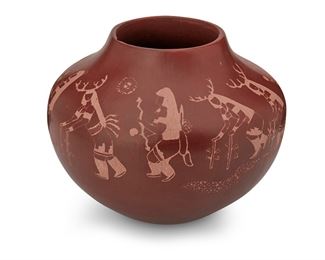 324
Ron Martinez, Looking Elk (B. 1978, Isleta/Taos Pueblo)
"The Dance," 1998
Signed and dated to the underside: Ron Martinez Looking-Elk / Isleta/Taos / 98
The redware pottery jar with burnished red slip glaze and shallow sgraffito dance scene to the shoulder
9" H x 11" Dia.
Estimate: $200 - $400