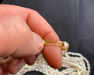 $125. 14 kt gold clasp with 9 strands of fresh water pearls. 