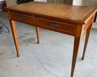 $150. Wooden desk with leather top. No name. Measures 39" wide x 23.5" deep x 30" tall. Overall very nice condition. 