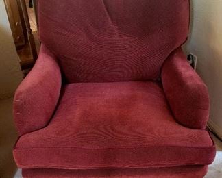 One of a pair of red club chairs