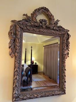 $1000 USD      Ornate Carved Large Mirror MK144-25      Description: Outstanding quality carved walnut rectangular wall mirror with an outstanding beautiful quality carved walnut frame with a wreath above carved acanthus leaves. The exceptional quality of the craftsmanship and design are evident throughout this special piece.
Condition: Very good 
Dimensions: 23.5 x 32"H The mirror measures 19.75" tall and 15" wide.
Local pick up McLean VA.  Contact us for shipper suggestions.      https://goodbyhello.com/products/ornate-carved-large-mirror-mk144-25?_pos=9&_sid=dcf795ae1&_ss=r