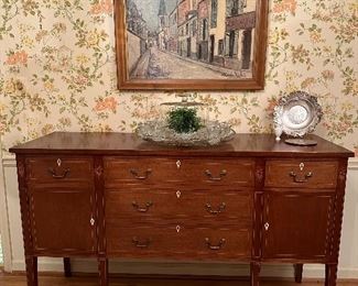 Sideboard with sleek, tapered legs and a subtle inlay border pattern throughout 