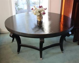 Large round ebonized cocktail table