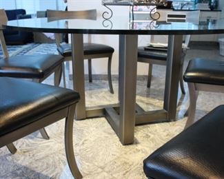 Kitchen glass top table with 6 “Design Institute of America” brushed steel Klismos style chairs