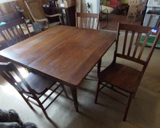 Antique five leg oak table and four chairs