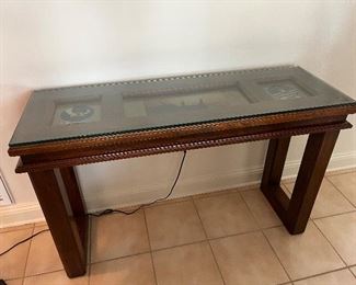 51 - $250 Hall wood table 31x49x16 Tom Cat plane memorabilia (crack glass corner)
