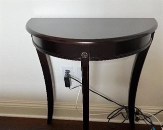 75 - $50 	Small demi lune table black burgundy 24Lx12Dx29H		
