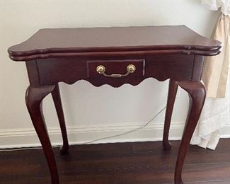 76 - $150 	mahogany stained Game table 31Hx32Lx16W The Bombay Company		
