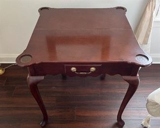 76 - $150 	mahogany stained Game table 31Hx32Lx16W The Bombay Company		
