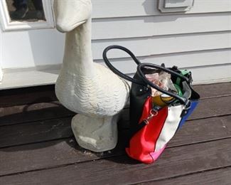 Cement goose with several outfits